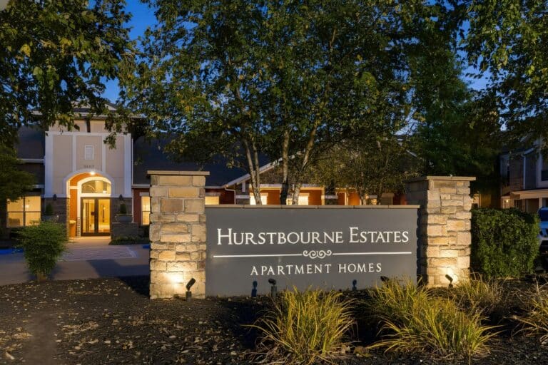 Leasing office at night with sign that reads: Hurstbourne estates apartment homes